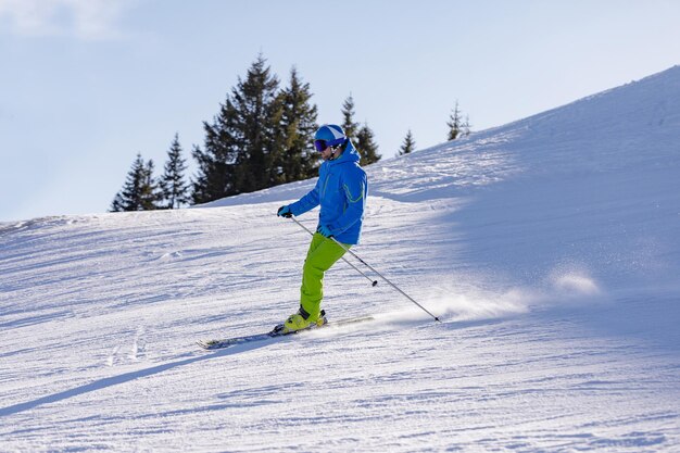 L'uomo e la donna che sciano e fanno snowboard nelle montagne sciano il reso