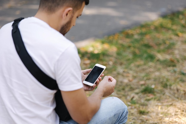 L'uomo prende la sim card dal suo telefono vista posteriore dell'uomo imposta il suo cellulare