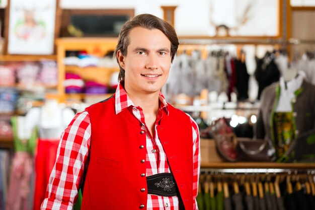 L'uomo sta provando Tracht o Lederhosen in un negozio