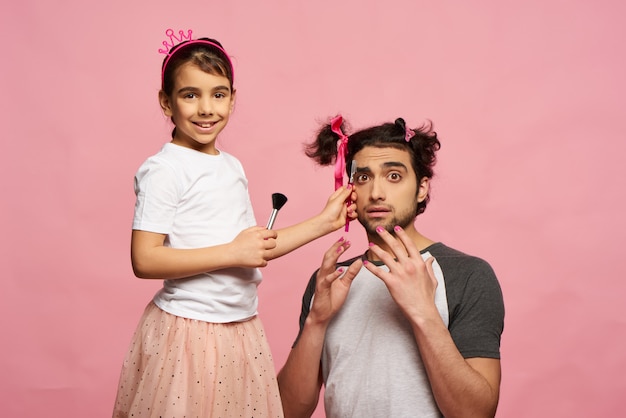 La bambina fa il trucco al padre