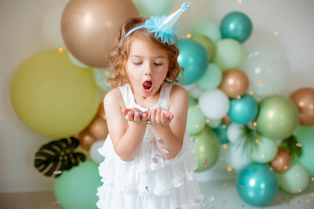 La bambina festeggia il compleanno soffiando coriandoli