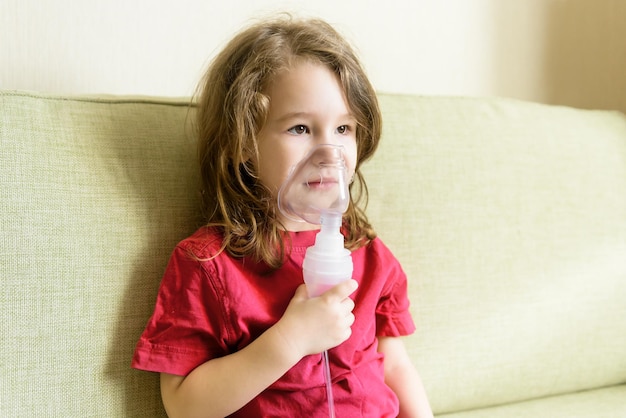 La bambina tiene la maschera dell'inalatore a casa