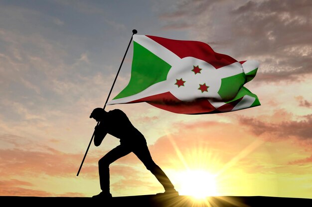 La bandiera del Burundi viene spinta nel terreno da un rendering 3D di silhouette maschile