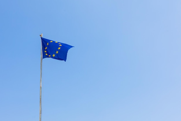 La bandiera dell'Unione europea sventola sullo sfondo del cielo blu Banner posto per il testo