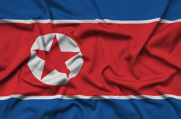 La bandiera della Corea del Nord è raffigurata su un tessuto sportivo con molte pieghe.