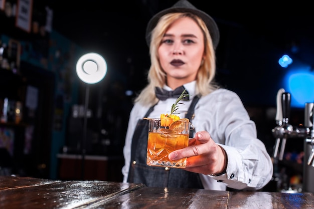 La barista ragazza crea un cocktail nella birreria