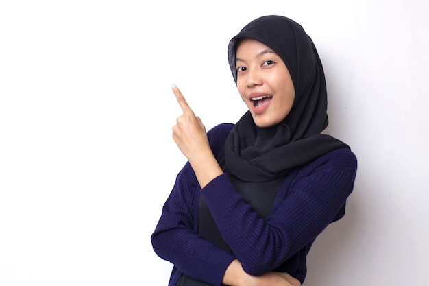 La bella donna asiatica indossa un hijab con la punta della mano su uno spazio vuoto