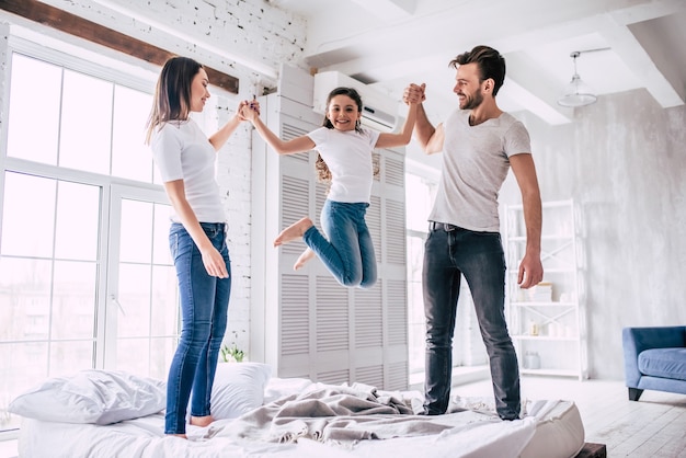 La bella famiglia che salta sul letto