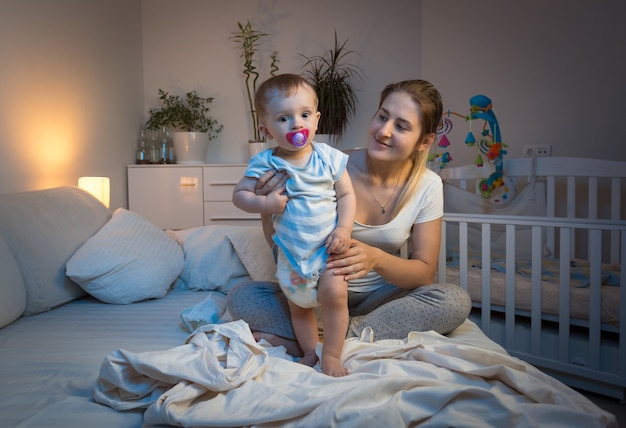 La bella giovane madre si sta prendendo cura del suo bambino