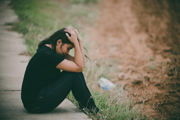 La bella ragazza asiatica si sente sola nella foresta Concetto di donna tristePopolo della ThailandiaLady tristezza per l'amore dal fidanzatoSi sente il cuore spezzato