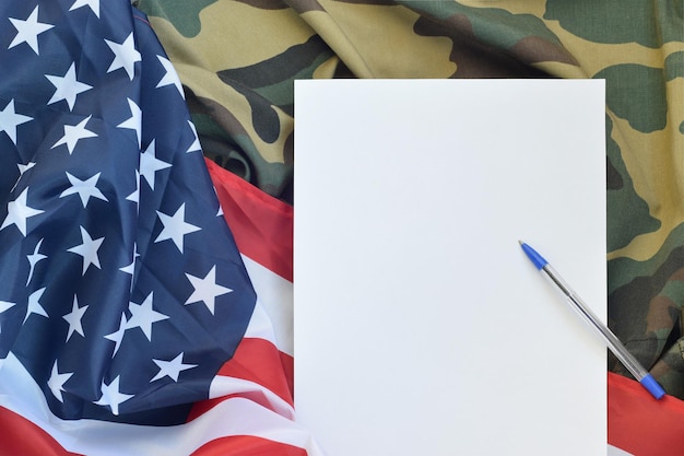 La carta bianca si trova sulla bandiera degli Stati Uniti d'America e sulla giacca uniforme militare piegata Simboli militari sfondo concettuale banner e spazio di copia