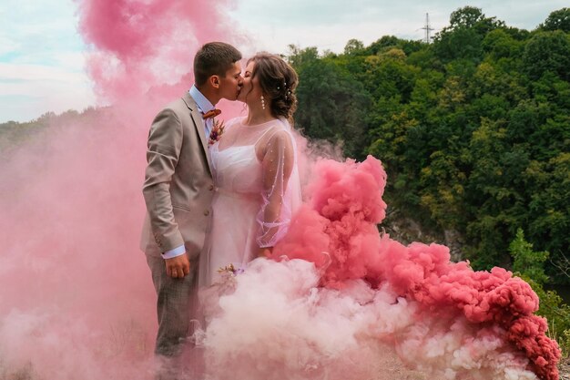 La coppia in piedi in mezzo ai fiori rosa