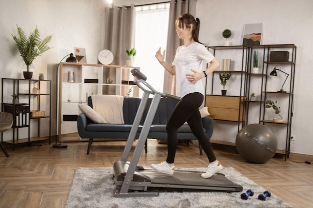 La donna atletica e muscolare si allena attivamente nell'appartamento moderno