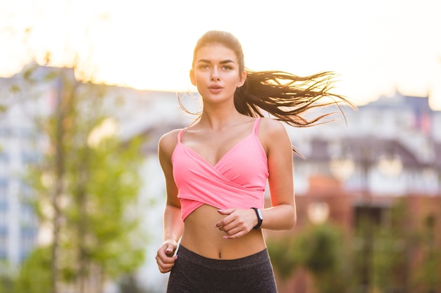 La donna che corre sullo sfondo del tramonto