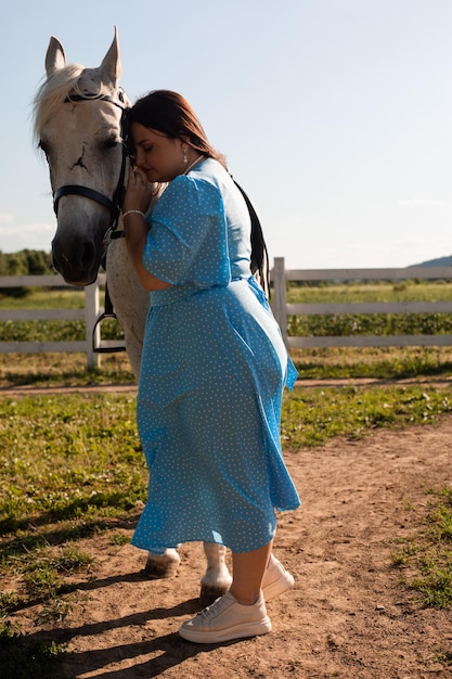 La donna con i capelli ricci si stringe al suo cavallo