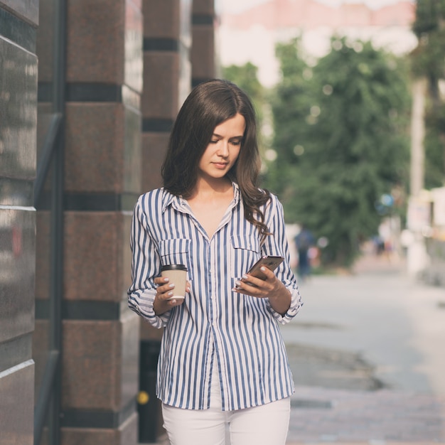 La donna di affari usa un telefono cellulare.