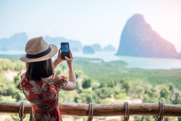 La donna felice del viaggiatore gode del punto di vista della baia di Phang Nga