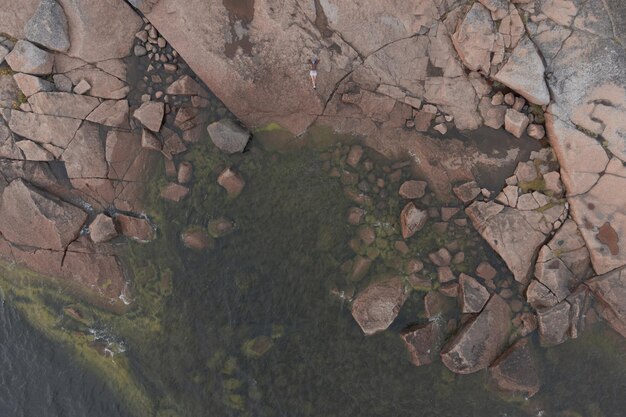 La donna giace sulla costa granitica del mare