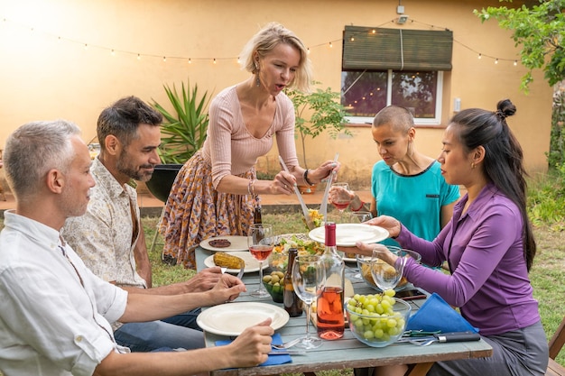 La donna serve il cibo a casa patio sorride concetto di allegria