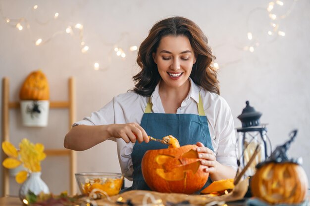 La donna sta intagliando la zucca