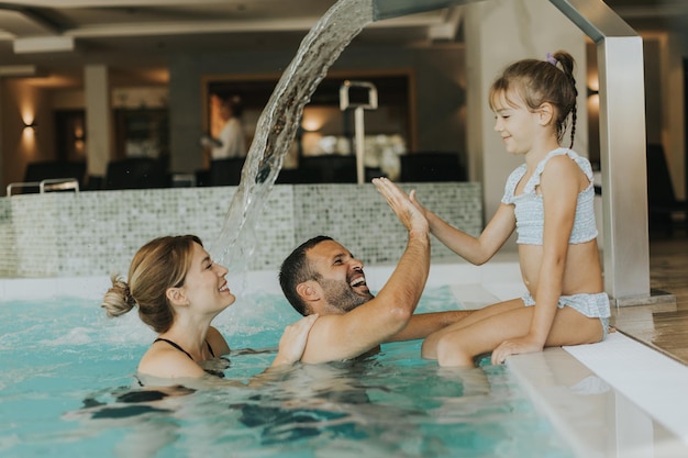 La famiglia si diverte nella piscina coperta