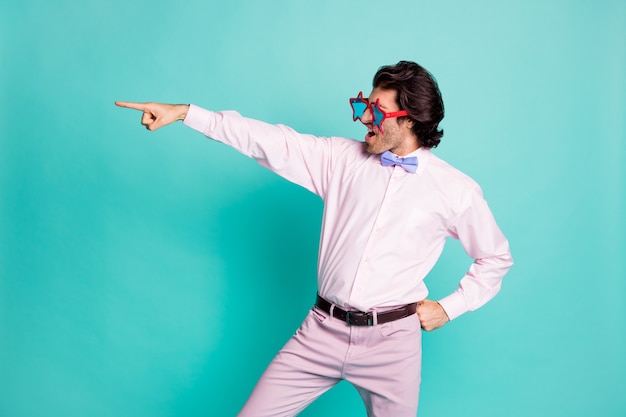 La foto del profilo dell'affascinante ballerino di capelli ricci brunetta indossa un abito rosa che punta guardando lo sfondo di colore verde acqua isolato spazio vuoto