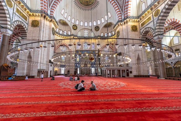 La gente si siede e prega nella moschea di Suleymaniye