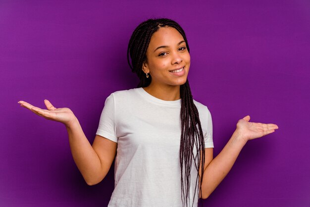 La giovane donna afroamericana fa la scala con le braccia, si sente felice e fiduciosa.