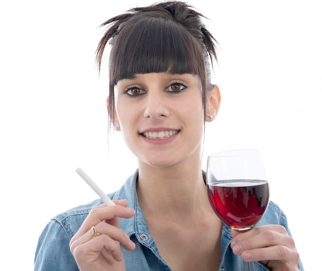 La giovane donna beve un bicchiere di vino rosso