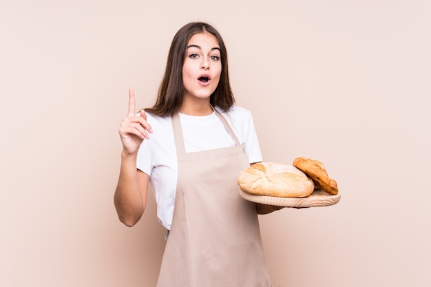 La giovane donna caucasica del panettiere ha isolato avendo un'idea, concetto di ispirazione.