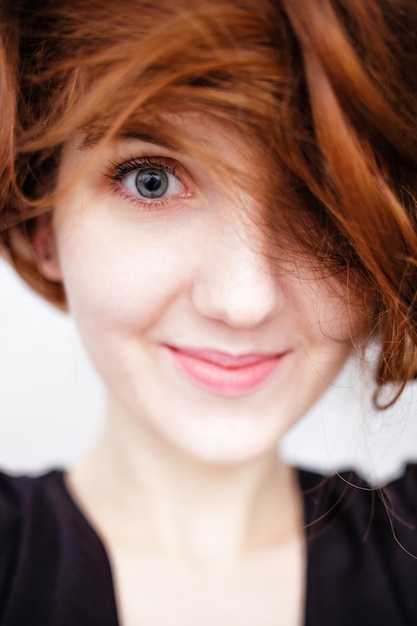 La giovane ragazza caucasica dai capelli rossi sorride