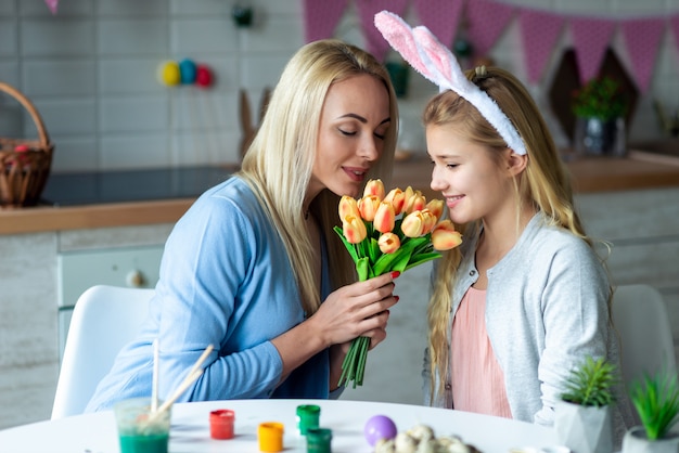 La madre e sua figlia annusano i tulipani