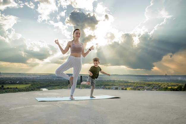 La madre sportiva sta facendo allenamento con il figlioletto. Concetto di sport