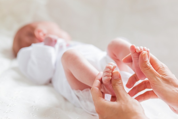 La madre tiene i tacchi nudi del neonato