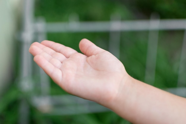 La mano di un bambino cattura una goccia d'acqua