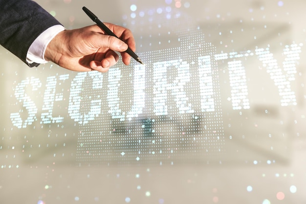 La mano maschile con la penna disegna il concetto creativo di sicurezza informatica virtuale su sfondo ufficio sfocato Doppia esposizione