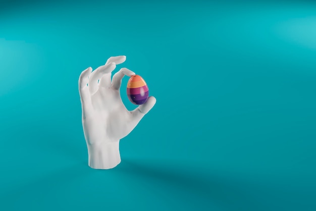 La mano tiene l'uovo di pasqua in vernice blu d render