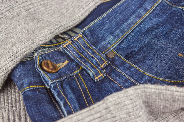 La parte superiore dei jeans. Parte anteriore dei jeans sullo sfondo del maglione, primo piano.