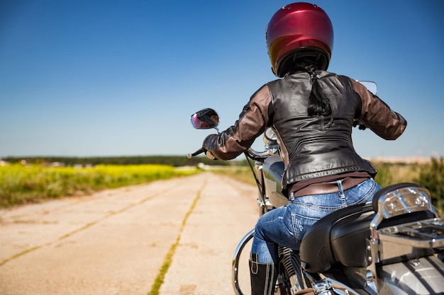 La ragazza del motociclista guida una moto sotto la pioggia. Visuale in prima persona.