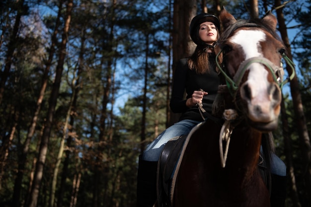 La ragazza di equitazione sta addestrando il suo cavallo