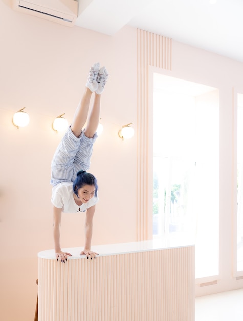 La ragazza flessibile pratica lo stretching e la verticale a casa il concetto di creatività dell'individualità