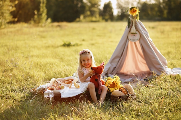 la ragazza sorride e tiene un peluche. picnic estivo