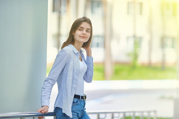 La ragazza sta vicino all'edificio. Copia spazio.