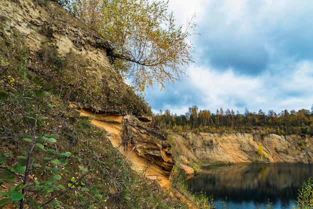 La riva sabbiosa di un lago di montagna in autunno .regione di Leningrado.