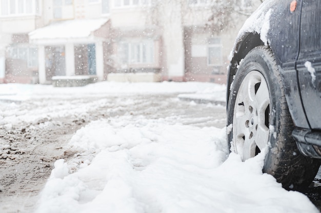 La ruota di un'auto tra la neve bagnata.