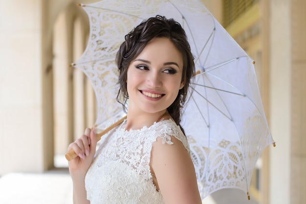 La sposa con ombrello bianco