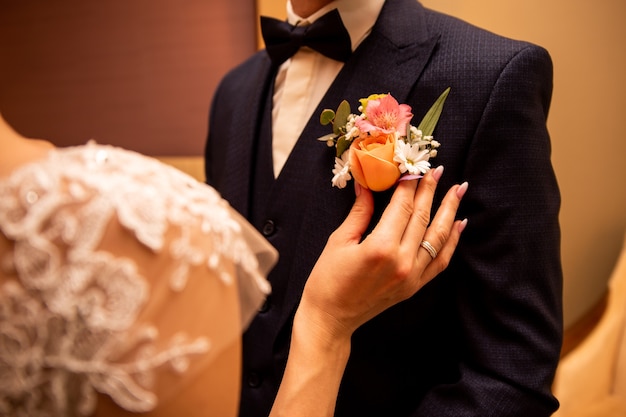 La sposa regola il fiore all'occhiello per lo sposo