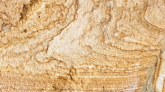 La superficie dell'arenaria con venature marroni ondulate. Struttura dell'agata solforata. Ampia immagine della struttura di pietra naturale marrone Sfalerite. Bellissimo motivo ondulato del taglio del primo piano della pietra di Schalenblende.