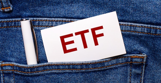 La tasca posteriore dei blue jeans contiene una penna bianca e una carta bianca con il testo ETF Exchange Traded Funds