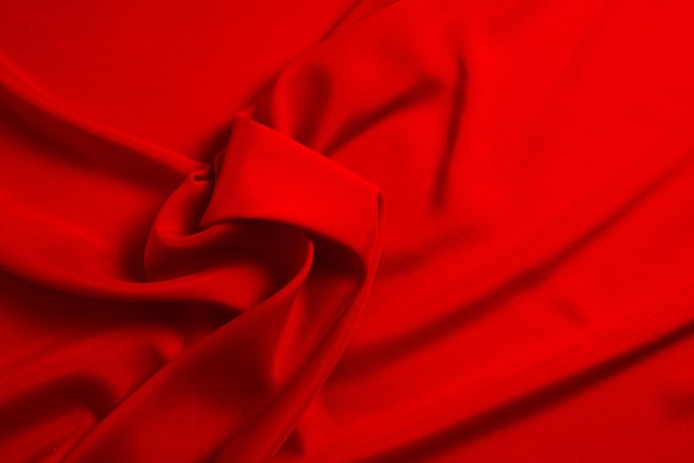 La trama del tessuto di lusso in seta rossa o satinata può essere utilizzata come sfondo astratto Vista dall'alto